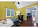 Bright bedroom featuring hardwood floors, a ceiling fan, and a large window with natural light at 4924 Stoneyoak Ln, Raleigh, NC 27610