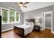Charming bedroom with large windows, hardwood floors, and neutral paint at 4924 Stoneyoak Ln, Raleigh, NC 27610