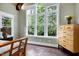 Bedroom featuring large windows, neutral paint, beamed ceilings, and a stylish dresser at 4924 Stoneyoak Ln, Raleigh, NC 27610