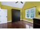 Bedroom featuring hardwood floors, a ceiling fan, a large window and a closed Murphy bed at 4924 Stoneyoak Ln, Raleigh, NC 27610