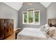 Charming bedroom with large windows, hardwood floors, and neutral paint at 4924 Stoneyoak Ln, Raleigh, NC 27610