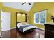 Bedroom with hardwood floors, a window with natural light and a Murphy bed for space saving at 4924 Stoneyoak Ln, Raleigh, NC 27610