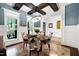 Cozy dining area with unique chair fabrics, modern lighting, and views of the outdoor scenery at 4924 Stoneyoak Ln, Raleigh, NC 27610