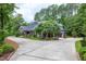 Long private driveway leading to a charming home surrounded by mature trees and landscaping at 4924 Stoneyoak Ln, Raleigh, NC 27610