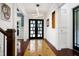Bright foyer with modern lighting, tiled floors, and striking black double doors at 4924 Stoneyoak Ln, Raleigh, NC 27610