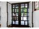 Striking decorative glass front doors open to a view of the landscaped front yard at 4924 Stoneyoak Ln, Raleigh, NC 27610