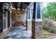 Cozy front porch with stone pillars, swing, and beautiful tile flooring at 4924 Stoneyoak Ln, Raleigh, NC 27610