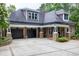 Spacious three-car garage with stone pillars and inviting entryway at 4924 Stoneyoak Ln, Raleigh, NC 27610