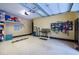 Garage featuring a workbench, storage shelves and a sealed floor for easy maintenance at 4924 Stoneyoak Ln, Raleigh, NC 27610