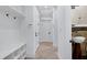 Hallway boasting a storage bench and wall mounted sink and stone tile flooring at 4924 Stoneyoak Ln, Raleigh, NC 27610