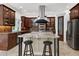 Gourmet kitchen with stainless steel appliances, granite countertops, and bar stool seating at 4924 Stoneyoak Ln, Raleigh, NC 27610