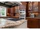 Gourmet kitchen with stainless steel appliances, island range, and custom cabinetry at 4924 Stoneyoak Ln, Raleigh, NC 27610