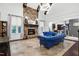 Bright living room featuring a stone fireplace, modern lighting, and opens to kitchen at 4924 Stoneyoak Ln, Raleigh, NC 27610