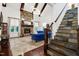 Bright living room with stone fireplace, comfortable seating, and staircase with stone risers at 4924 Stoneyoak Ln, Raleigh, NC 27610