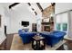 Open living room with stone fireplace, vaulted ceilings, wooden beams and comfortable seating at 4924 Stoneyoak Ln, Raleigh, NC 27610