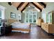 Large main bedroom with a beamed ceiling, large windows and stylish wooden furniture at 4924 Stoneyoak Ln, Raleigh, NC 27610