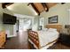Bright main bedroom offering natural light, neutral paint, beamed ceilings, and a bed at 4924 Stoneyoak Ln, Raleigh, NC 27610