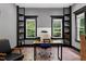Bright office featuring a large desk, natural light from multiple windows, and built in shelving at 4924 Stoneyoak Ln, Raleigh, NC 27610