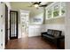 Sitting area featuring a leather couch, wainscotting, and a doorway to another room at 4924 Stoneyoak Ln, Raleigh, NC 27610
