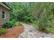 The backyard features a stone path and lush landscaping at 4924 Stoneyoak Ln, Raleigh, NC 27610