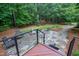 A stone patio with a fire pit and seating are just a few steps down from the back deck at 4924 Stoneyoak Ln, Raleigh, NC 27610