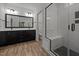 Modern bathroom with black vanity, dual sinks, large mirror, and walk-in shower at 5034 Blendon Trl, Garner, NC 27529
