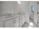This bathroom features double sinks and marble countertops with a window providing natural light at 5034 Blendon Trl, Garner, NC 27529