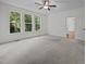 Spacious bedroom features plush carpet, three large windows, and ceiling fan at 5034 Blendon Trl, Garner, NC 27529