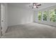 Spacious bedroom features plush carpet, three large windows, and neutral color palette at 5034 Blendon Trl, Garner, NC 27529