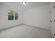 A bright bedroom with plush carpeting and a large window overlooking green space at 5034 Blendon Trl, Garner, NC 27529