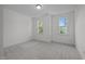 Bright bedroom with two windows offering verdant views and plush carpeting at 5034 Blendon Trl, Garner, NC 27529