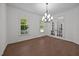 Dining room featuring a modern chandelier, hardwood floors, and french doors at 5034 Blendon Trl, Garner, NC 27529