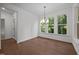Bright dining room with hardwood floors, a modern chandelier, and three large windows at 5034 Blendon Trl, Garner, NC 27529
