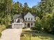 Charming two-story farmhouse-style home featuring a manicured front lawn and a welcoming front porch at 5034 Blendon Trl, Garner, NC 27529
