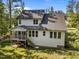 Aerial view of the exterior back of the house featuring a lawn, porch, and nearby trees at 5034 Blendon Trl, Garner, NC 27529