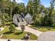 Striking two-story home with a three-car garage, lush lawn, mature trees, and a circular driveway at 5034 Blendon Trl, Garner, NC 27529