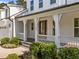 Close up of the inviting front porch with modern columns, and manicured landscaping at 5034 Blendon Trl, Garner, NC 27529