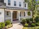Inviting front porch with stylish columns, a wood door with glass, and well-maintained landscaping at 5034 Blendon Trl, Garner, NC 27529