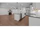 Open-concept kitchen with stainless steel appliances, a large island, and view to fireplace at 5034 Blendon Trl, Garner, NC 27529
