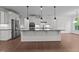 Bright kitchen features a large island, stainless steel appliances, and white cabinetry at 5034 Blendon Trl, Garner, NC 27529
