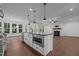 Open-concept kitchen with stainless steel appliances and island with breakfast bar at 5034 Blendon Trl, Garner, NC 27529