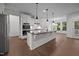 Spacious kitchen features a large island, stainless steel appliances, and white cabinetry at 5034 Blendon Trl, Garner, NC 27529
