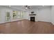 Bright living room features a modern fireplace, hardwood floors, and a patio door to a covered porch at 5034 Blendon Trl, Garner, NC 27529