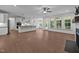 Open-concept living space with a modern fireplace, hardwood floors, and a view of the kitchen island at 5034 Blendon Trl, Garner, NC 27529