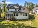 A bright rear exterior featuring a screened-in porch and steps to a spacious yard at 5034 Blendon Trl, Garner, NC 27529