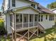 View of the rear screened porch and stairs to backyard on a sunny day at 5034 Blendon Trl, Garner, NC 27529