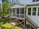 View of the rear screened porch, stairs to backyard and wooded area in the distance at 5034 Blendon Trl, Garner, NC 27529