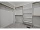 Walk-in closet features custom shelving, carpeted floors, and ample storage space at 5034 Blendon Trl, Garner, NC 27529