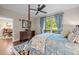 Cozy bedroom with a four-poster bed, blue patterned bedding, and ample natural light at 515 N Churton St # 203, Hillsborough, NC 27278