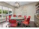 Stylish conference room with a round table, red chairs, and natural light from a large window at 515 N Churton St # 203, Hillsborough, NC 27278